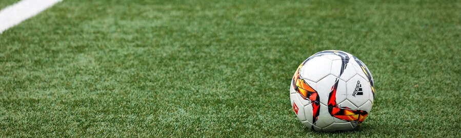 Nahaufnahme Fußball-Feld: Fußball liegt auf dem Rasen