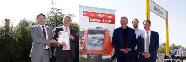 Übergabe des Baurechts für die Taunusbahn 4 Männer zwei links zwei rechts, daneben ein Banner auf einem Bahnsteig in Usingen